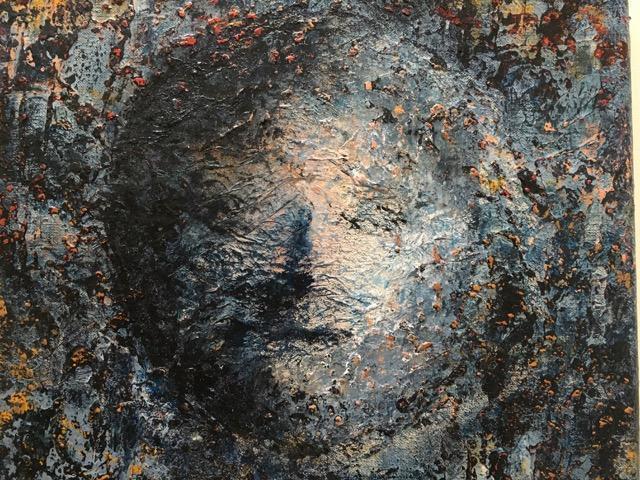 image of a painting with face appearing to come out of the canvas